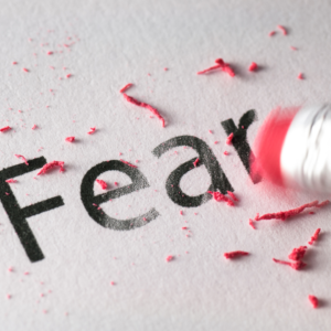 Overcoming Fear and Self Doubt. The image is of the word fear being erased.