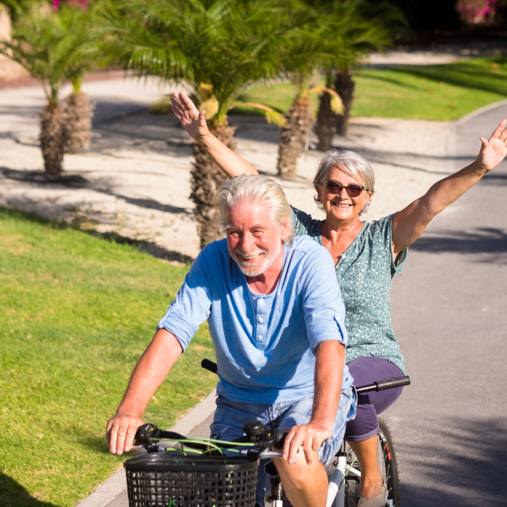 Overcoming fear and self doubt at any age. Image shows two elderly people riding a bike.