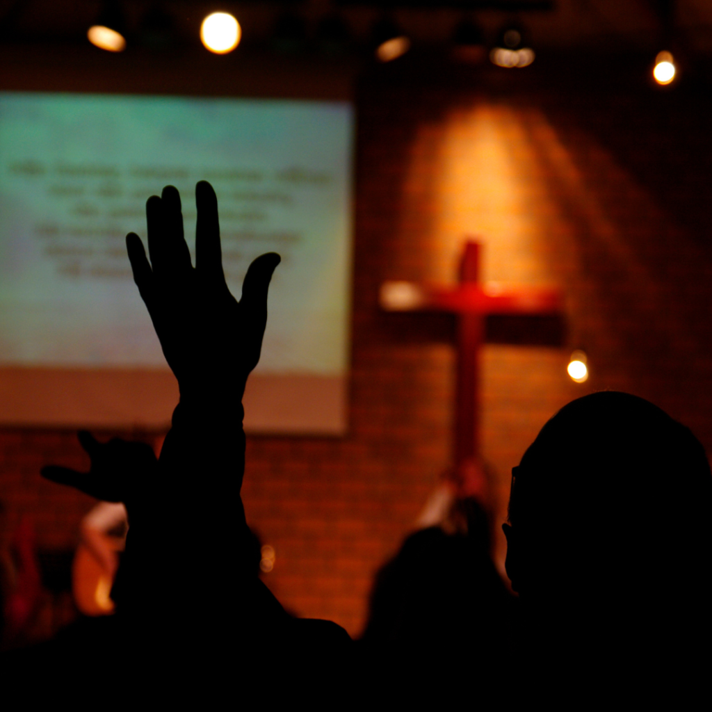 Should Christian Listen to Secular Music? The Origins of music and its impact on worship. This image is a photo of a group of people engaged in worship.