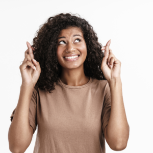 Are You a Superstitious Christian? Sometimes we follow rituals and beliefs but don’t even know why we believe what we believe. Image is of a woman crossing her fingers looking anxious.